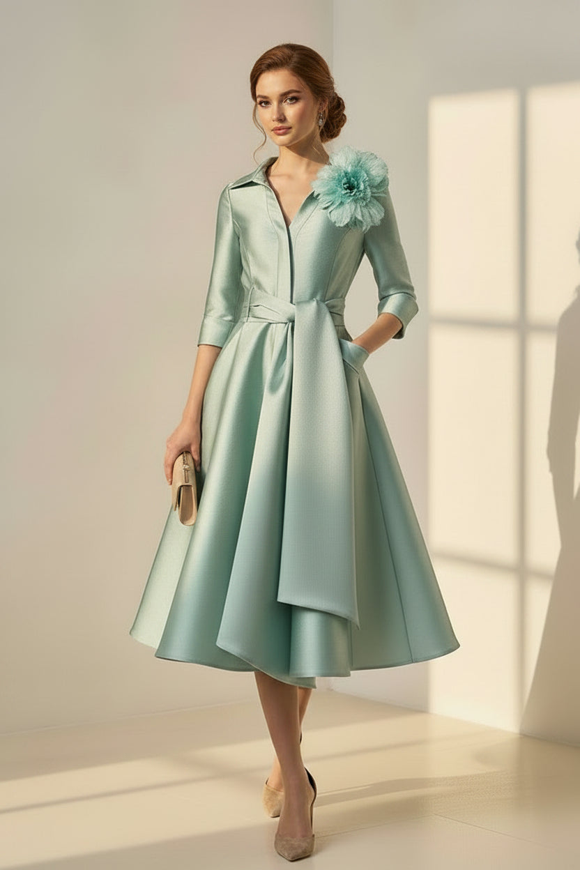 Vestido midi de satén con corte en A y broche floral